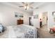 Cozy main bedroom with tray ceiling, neutral tones, wood furniture, and ensuite bathroom access at 1881 Moonseed Dr., Longs, SC 29568