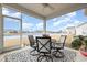 Inviting screened-in patio overlooking a lake view, featuring a ceiling fan and outdoor dining set at 1881 Moonseed Dr., Longs, SC 29568