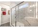 Sleek walk-in shower with marble tile, glass enclosure, and a window offering natural light at 1881 Moonseed Dr., Longs, SC 29568