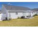 Spacious backyard with a patio seating area, manicured lawn, and privacy fence at 217 Sienna Dr., Little River, SC 29566