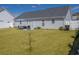 Expansive backyard with lush green grass, an outdoor patio with furniture, and a privacy fence at 217 Sienna Dr., Little River, SC 29566