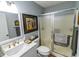 Updated bathroom with a modern vanity, framed mirror, and walk-in shower with sliding glass door at 217 Sienna Dr., Little River, SC 29566