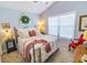 Cozy bedroom featuring a large window, soft carpet, and a decorative wreath at 217 Sienna Dr., Little River, SC 29566
