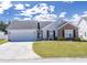 Charming single-story home with a well-manicured lawn, a two-car garage, and inviting curb appeal at 217 Sienna Dr., Little River, SC 29566