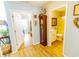 Inviting hallway with hardwood floors leading to bathroom and rooms with bright natural light at 217 Sienna Dr., Little River, SC 29566