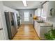 Bright kitchen with stainless steel appliances, granite countertops, and wood flooring at 217 Sienna Dr., Little River, SC 29566