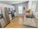 Well-lit kitchen featuring stainless steel appliances, granite countertops, and light gray walls at 217 Sienna Dr., Little River, SC 29566