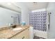 Cozy bathroom features granite countertop and a shower with a patterned curtain at 2258 Huntingdon Dr. # B, Myrtle Beach, SC 29575