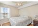 Cozy bedroom with laminate flooring, a ceiling fan, and lots of natural light from a large window at 2258 Huntingdon Dr. # B, Myrtle Beach, SC 29575