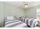 Charming bedroom with two twin beds, ceiling fan, and natural light at 2258 Huntingdon Dr. # B, Myrtle Beach, SC 29575