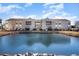 Exterior view of condo buildings next to a scenic pond at 2258 Huntingdon Dr. # B, Myrtle Beach, SC 29575