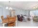 Sun-filled living area featuring tile floors, a dining area, and sliding doors to the screened porch at 2258 Huntingdon Dr. # B, Myrtle Beach, SC 29575
