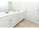 Bright bathroom featuring double sinks with white cabinets and tiled flooring at 225-B Dogwood Dr. N, Murrells Inlet, SC 29576