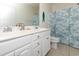 Bathroom featuring double sinks, white cabinetry, a shower curtain and beachy decor at 225-B Dogwood Dr. N, Murrells Inlet, SC 29576