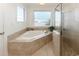 Bright bathroom featuring a soaking tub with views of the ocean and street beyond at 225-B Dogwood Dr. N, Murrells Inlet, SC 29576