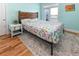 Bedroom with a wooden headboard, complemented by light blue walls and balcony access at 225-B Dogwood Dr. N, Murrells Inlet, SC 29576