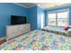 Bedroom featuring bright blue walls, and a full sized bed, offering a serene coastal atmosphere at 225-B Dogwood Dr. N, Murrells Inlet, SC 29576