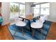 Bright dining area with natural wood table, white chairs and a view to the outdoor deck at 225-B Dogwood Dr. N, Murrells Inlet, SC 29576