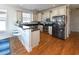 Charming kitchen with stainless steel appliances, breakfast bar and hardwood flooring, perfect for casual dining at 225-B Dogwood Dr. N, Murrells Inlet, SC 29576