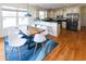 Bright open-concept kitchen with adjacent dining area featuring a natural wood table and stylish blue rug at 225-B Dogwood Dr. N, Murrells Inlet, SC 29576
