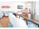 Open-concept living space featuring surfboard decor, a comfortable sofa and dining table at 225-B Dogwood Dr. N, Murrells Inlet, SC 29576