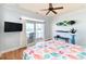 Serene primary bedroom with colorful bedding, balcony access, ceiling fan and a mounted television at 225-B Dogwood Dr. N, Murrells Inlet, SC 29576
