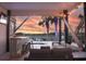 Outdoor living space with bar, television, outdoor furniture and a relaxing view of the sunset at 225-B Dogwood Dr. N, Murrells Inlet, SC 29576