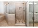 Tiled walk-in shower with glass door and neutral colored tile, offering modern convenience at 225-B Dogwood Dr. N, Murrells Inlet, SC 29576