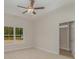 Comfortable bedroom with a ceiling fan, carpet flooring, a large window, and an ensuite bathroom at 227 Six Mile Creek Dr., Georgetown, SC 29440