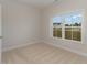 Bright bedroom featuring plush carpeting, neutral walls, a double-hung window, and ample natural light at 227 Six Mile Creek Dr., Georgetown, SC 29440