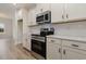 Modern kitchen with stainless steel appliances, white cabinets, quartz countertops, and subway tile backsplash at 227 Six Mile Creek Dr., Georgetown, SC 29440