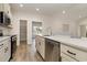 Bright kitchen with stainless steel appliances, white cabinets, and a large island with a sink and dishwasher at 227 Six Mile Creek Dr., Georgetown, SC 29440