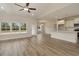 Living room with hardwood floors, neutral paint, and open to dining and kitchen areas at 227 Six Mile Creek Dr., Georgetown, SC 29440