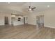 Open-concept kitchen and living room featuring hardwood floors, neutral paint tones, and bright lighting at 227 Six Mile Creek Dr., Georgetown, SC 29440