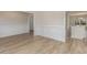 Living room with hardwood floors and views of kitchen and dining room with wainscoting and trim at 227 Six Mile Creek Dr., Georgetown, SC 29440