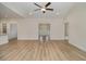 Open-concept living room featuring hardwood floors and neutral paint tones with vaulted ceiling and ceiling fan at 227 Six Mile Creek Dr., Georgetown, SC 29440