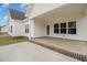 Back patio with white siding, brick trim, a ceiling fan, and large windows to the house at 227 Six Mile Creek Dr., Georgetown, SC 29440