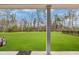 Expansive backyard with lush green lawn and trees; perfect for outdoor activities at 2418 Goldfinch Dr., Myrtle Beach, SC 29577