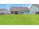 Spacious backyard featuring a covered patio, lush green lawn, and tidy landscaping, perfect for outdoor living at 2418 Goldfinch Dr., Myrtle Beach, SC 29577