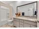Well-lit bathroom with granite countertop, large mirror, and a shower-tub combo at 2418 Goldfinch Dr., Myrtle Beach, SC 29577
