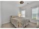 Cozy bedroom features a patterned bedspread, two windows, and a ceiling fan at 2418 Goldfinch Dr., Myrtle Beach, SC 29577