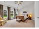 Spacious bedroom featuring large windows, neutral colors, and a ceiling fan for added comfort at 2418 Goldfinch Dr., Myrtle Beach, SC 29577