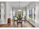 Inviting dining area filled with natural light from surrounding windows, offering a serene view at 2418 Goldfinch Dr., Myrtle Beach, SC 29577