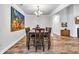 Spacious dining room with hardwood floors, a modern chandelier, and vibrant artwork at 2418 Goldfinch Dr., Myrtle Beach, SC 29577