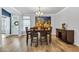 Spacious dining room with hardwood floors, a modern chandelier, and vibrant artwork at 2418 Goldfinch Dr., Myrtle Beach, SC 29577