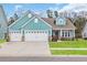 Charming single Gathering home with a three car garage, pristine landscaping, and a cozy front porch at 2418 Goldfinch Dr., Myrtle Beach, SC 29577
