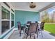 Cozy covered patio with dining set and grill; ideal for outdoor entertaining at 2418 Goldfinch Dr., Myrtle Beach, SC 29577