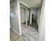 Entry hallway with wood-look flooring and mirrored closet doors with doors leading to bedrooms and bathrooms at 2710 N Ocean Blvd. # 1038, Myrtle Beach, SC 29577