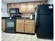 Kitchen features black appliances, granite countertops, and wood cabinets with tiled backsplash at 2710 N Ocean Blvd. # 1038, Myrtle Beach, SC 29577