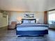 Bedroom featuring wood-look flooring, beach themed decor, and sliding door leading to an outdoor balcony at 2710 N Ocean Blvd. # 1038, Myrtle Beach, SC 29577